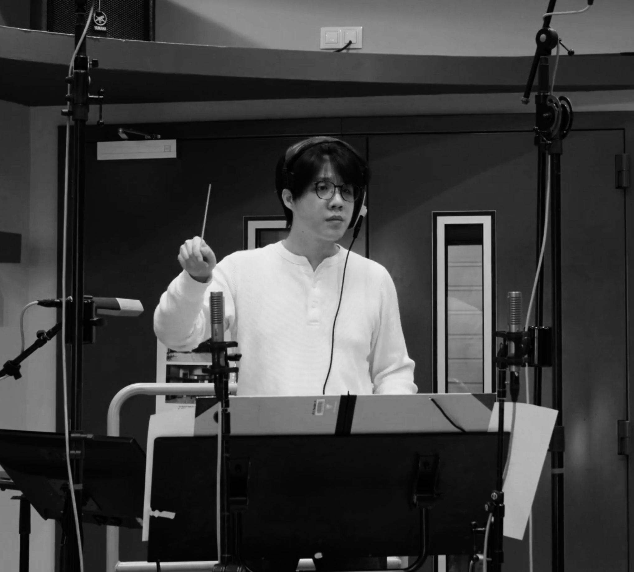Barry Zhang conducting in a recording studio.